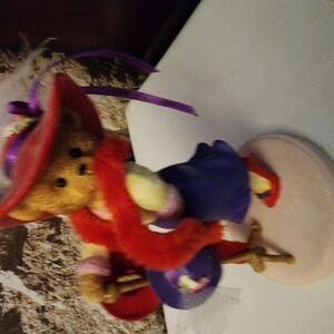 Colorful Bear Figurine with Red Hat and Purple Dress